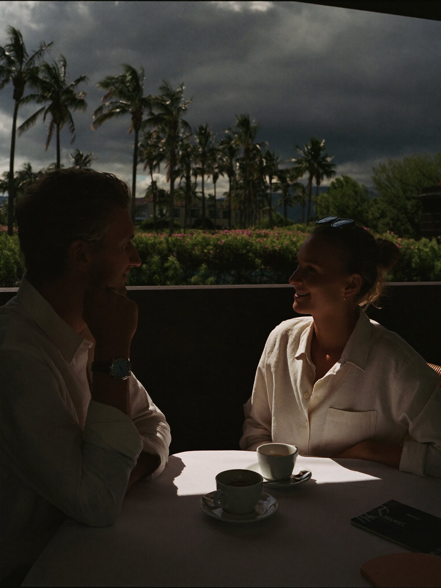 Two restaurant owners talking over coffee on their own terrace