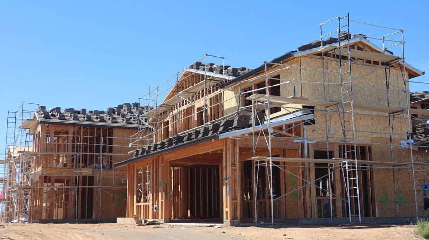 A wood-framed house under construction with scaffolding